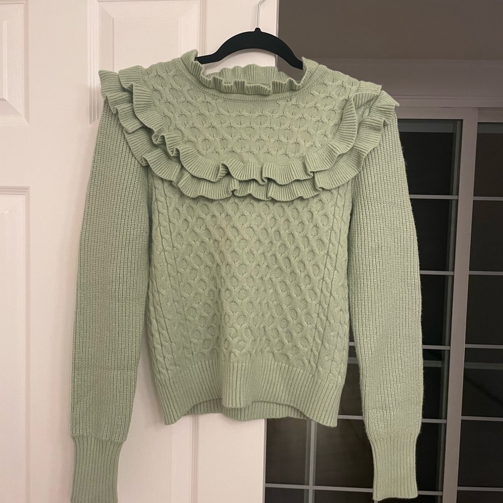Brand new pistachio green sweater with ruffles.